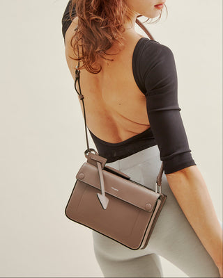 woman wearing Delaroq crossbody in mushroom-in-ballet-clothes